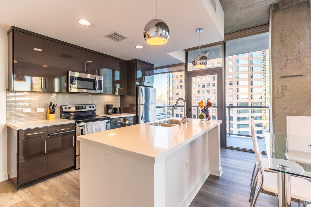 Kitchen remodel with white cabinetry and quartz counters